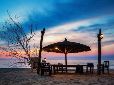 Wooden-chairs-and-umbrella-on-white-beach